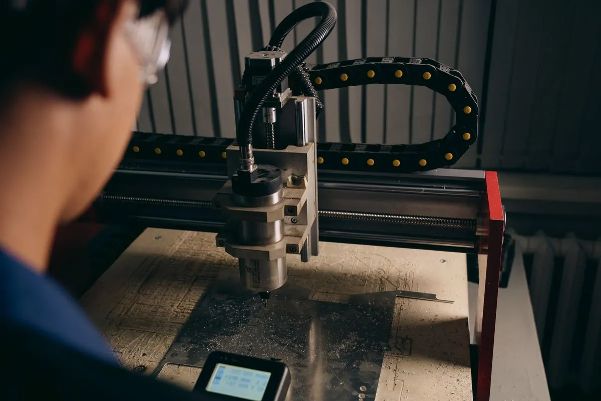 A machine cutting a panel in a workshop